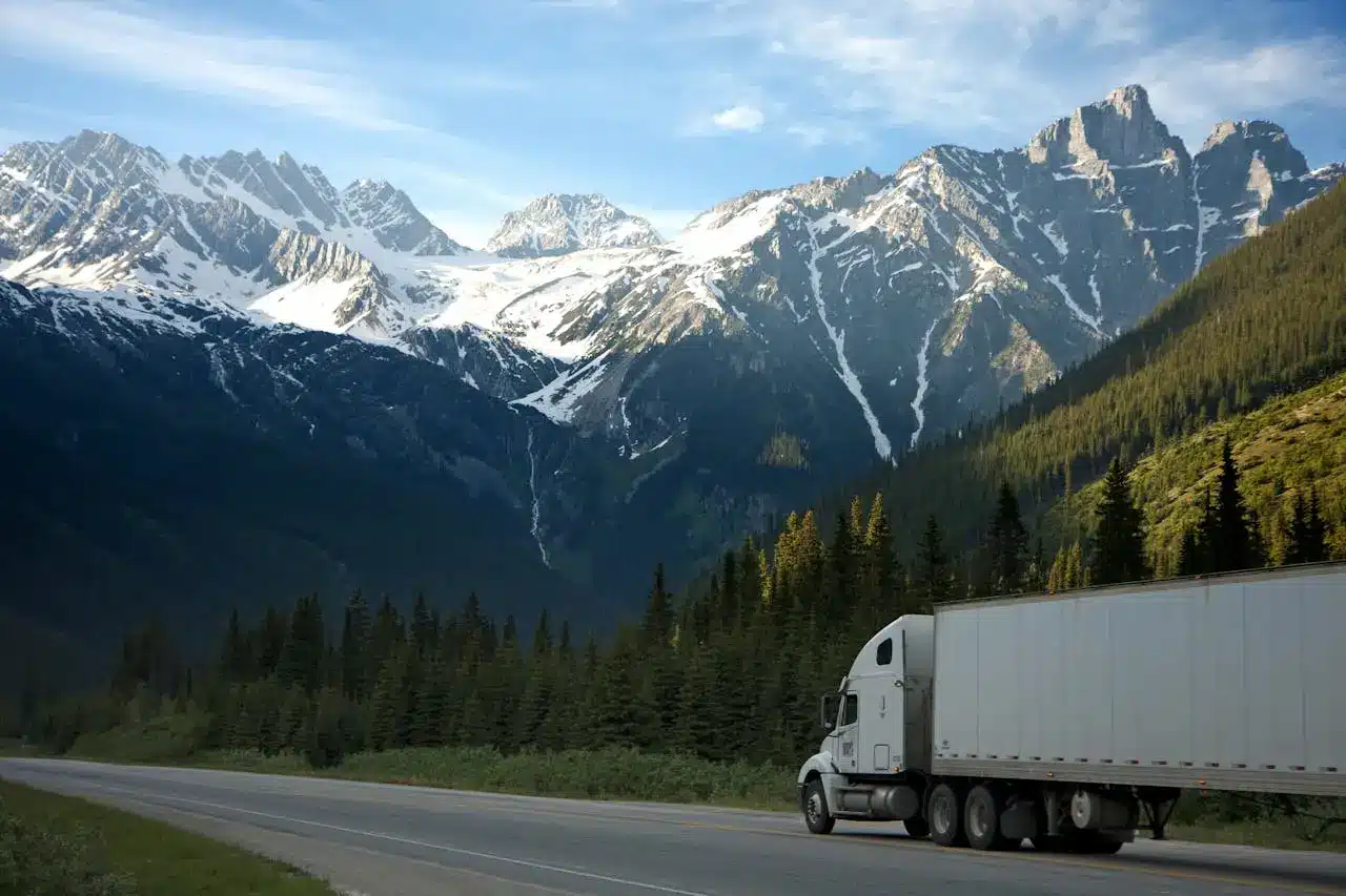 Truck Driving With Mountains Behind